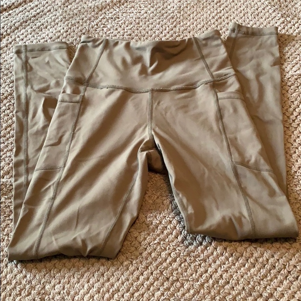 Olive green Ethos workout leggings with pockets.